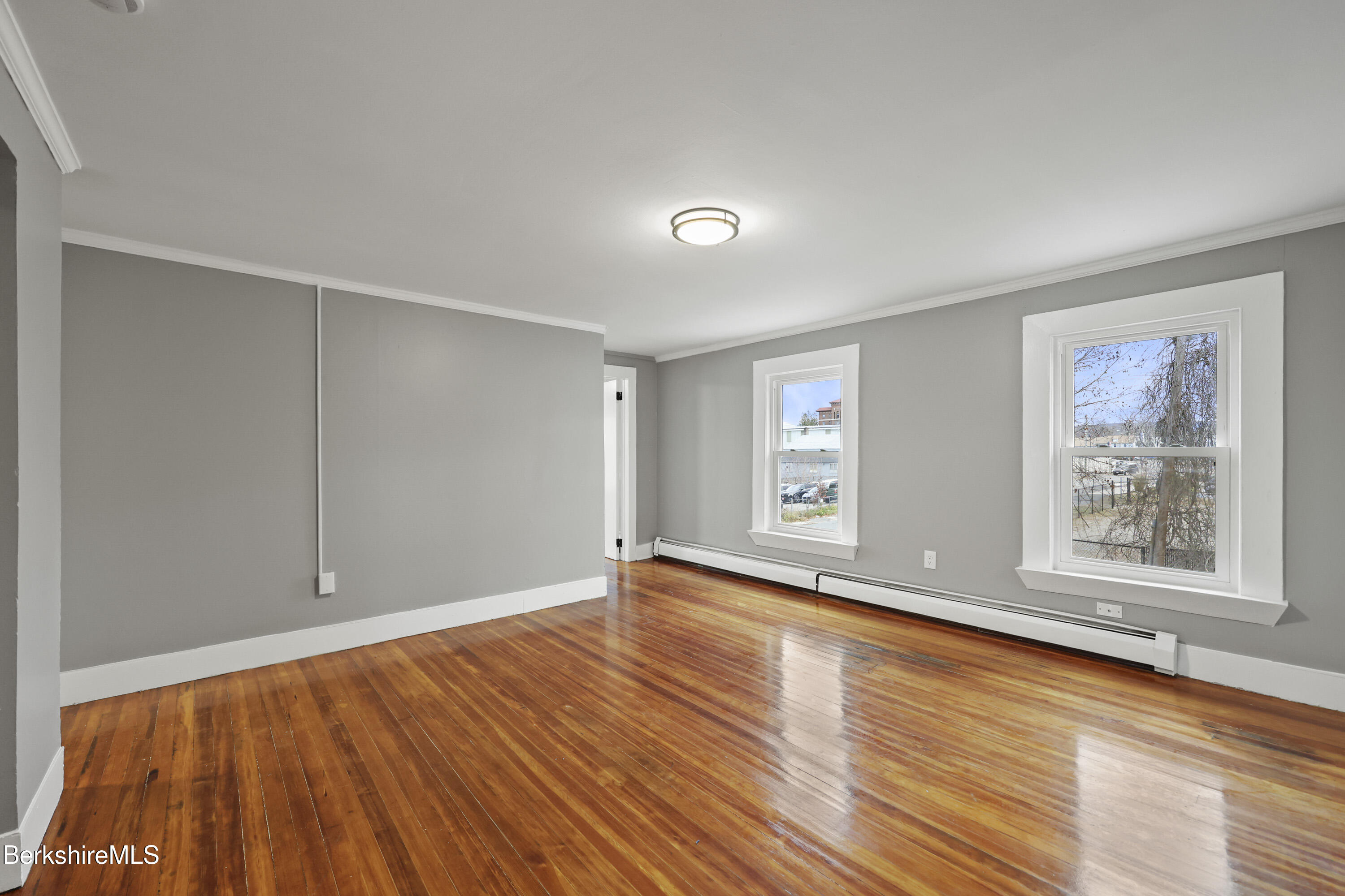 41-43 Reed Street Pittsfield, MA 01201 - Photo 29 of 56 an empty room with wooden floor and windows