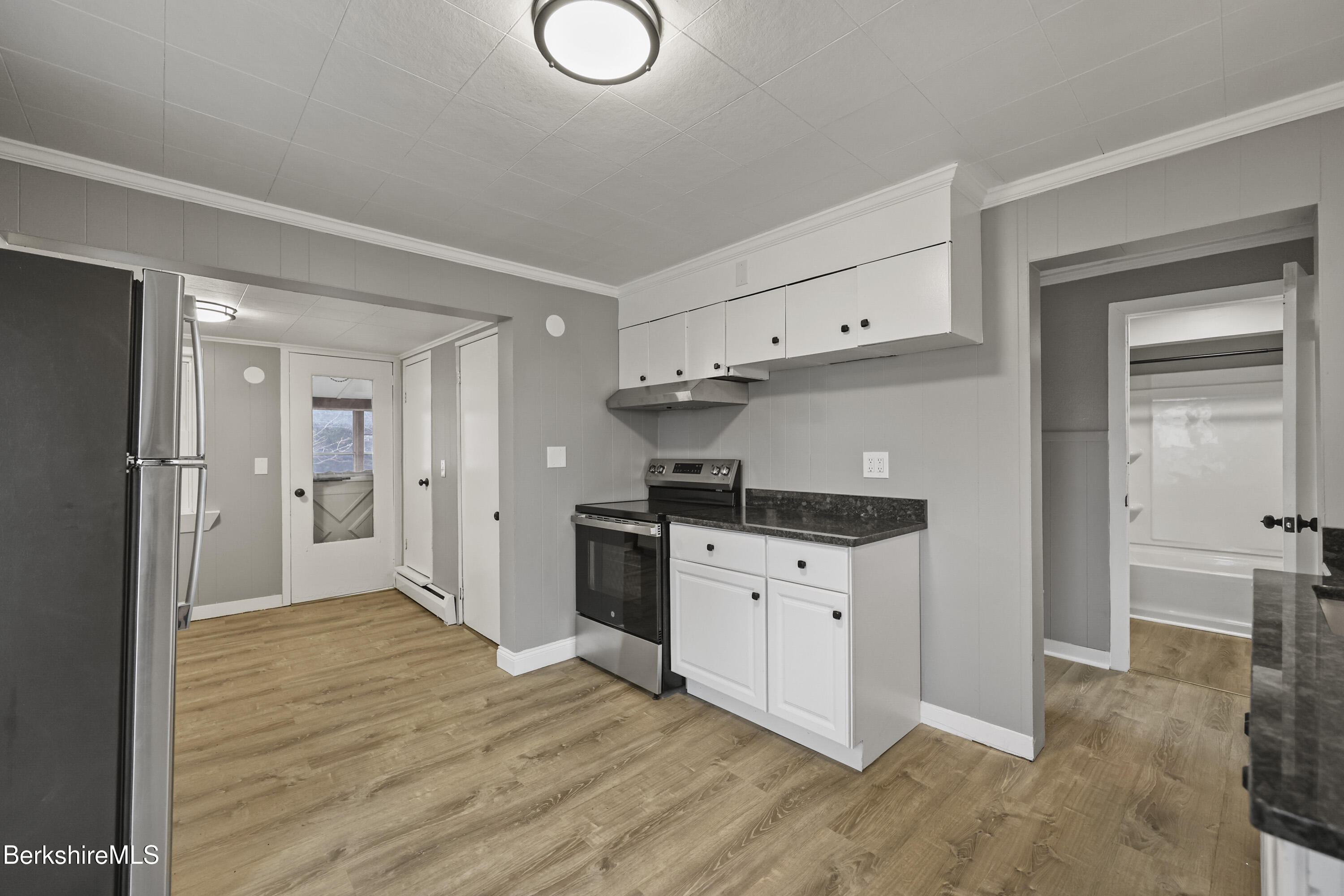 41-43 Reed Street Pittsfield, MA 01201 - Photo 32 of 56 a kitchen with stainless steel appliances granite countertop a refrigerator and a stove