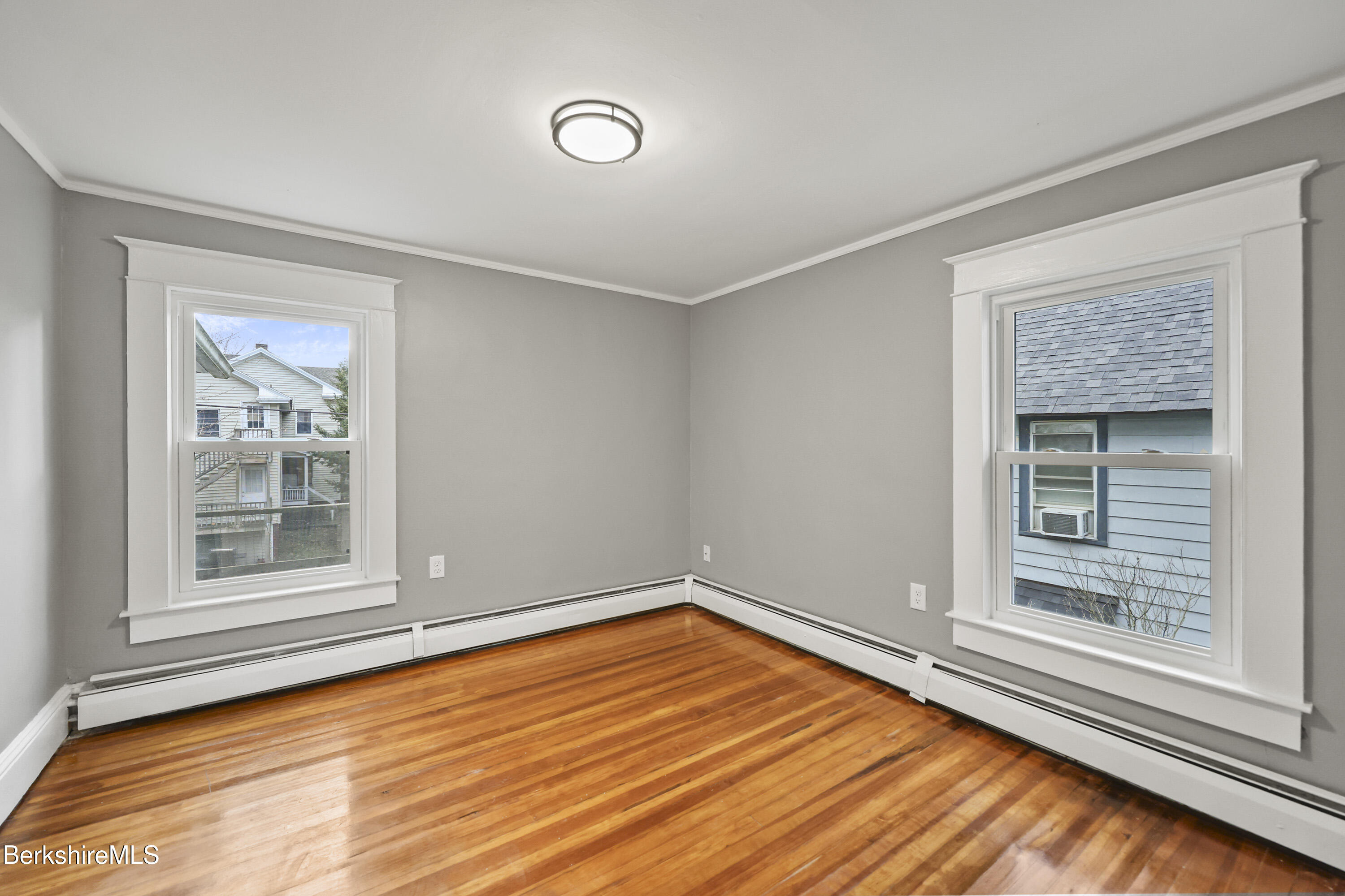 41-43 Reed Street Pittsfield, MA 01201 - Photo 39 of 56 an empty room with wooden floor and windows