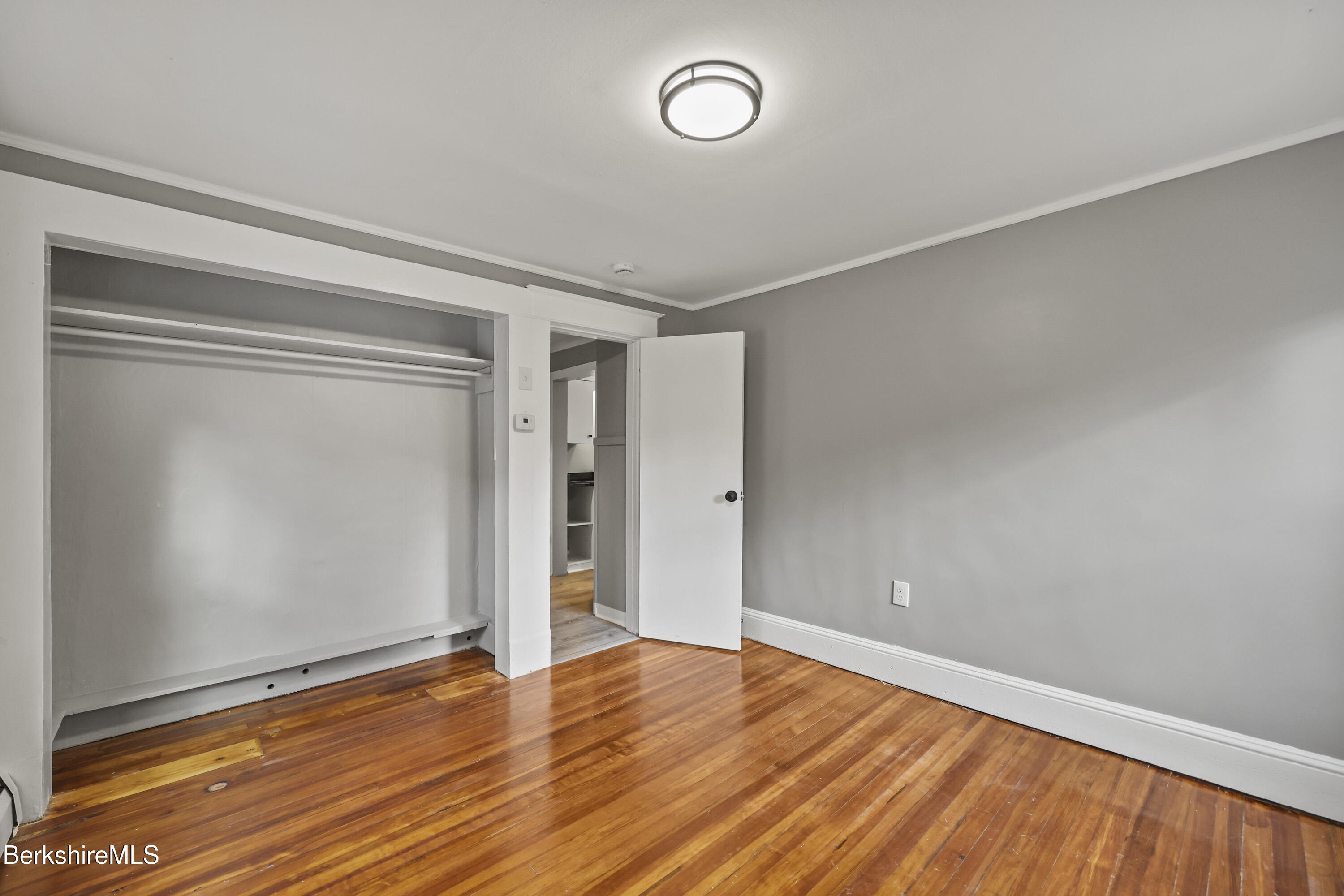 41-43 Reed Street Pittsfield, MA 01201 - Photo 40 of 56 a view of an empty room with wooden floor and a window