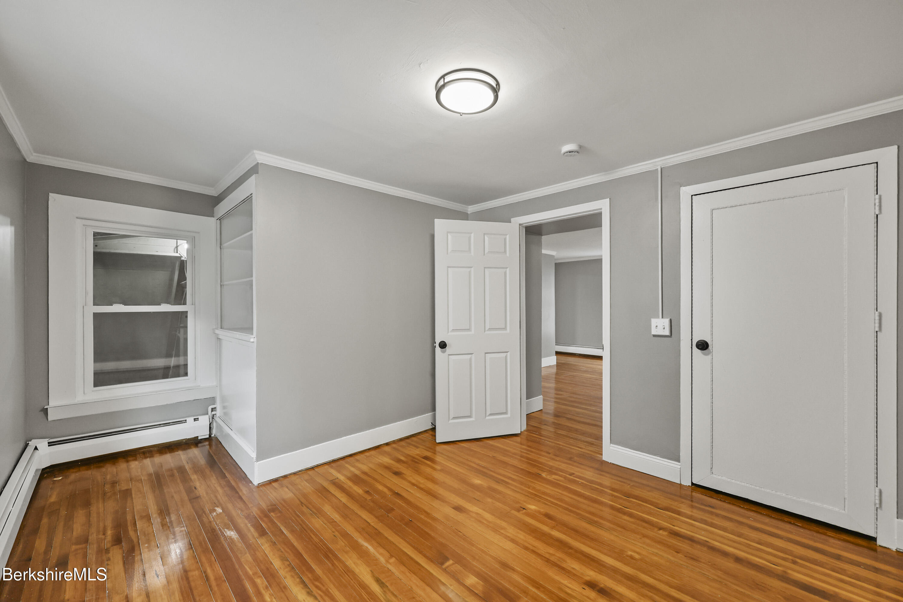 41-43 Reed Street Pittsfield, MA 01201 - Photo 42 of 56 a view of empty room with wooden floor and fan