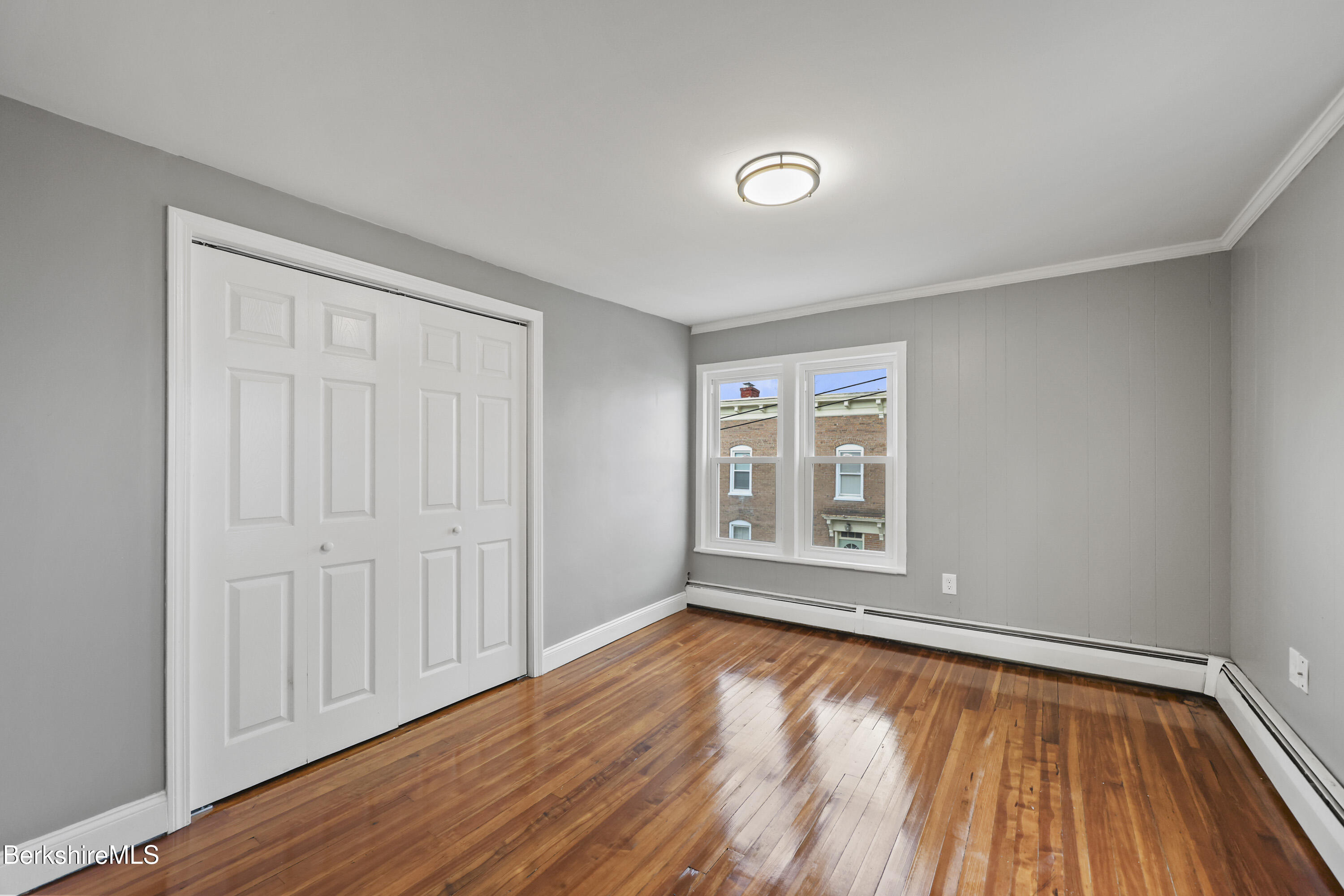 41-43 Reed Street Pittsfield, MA 01201 - Photo 43 of 56 wooden floor in an empty room with a window
