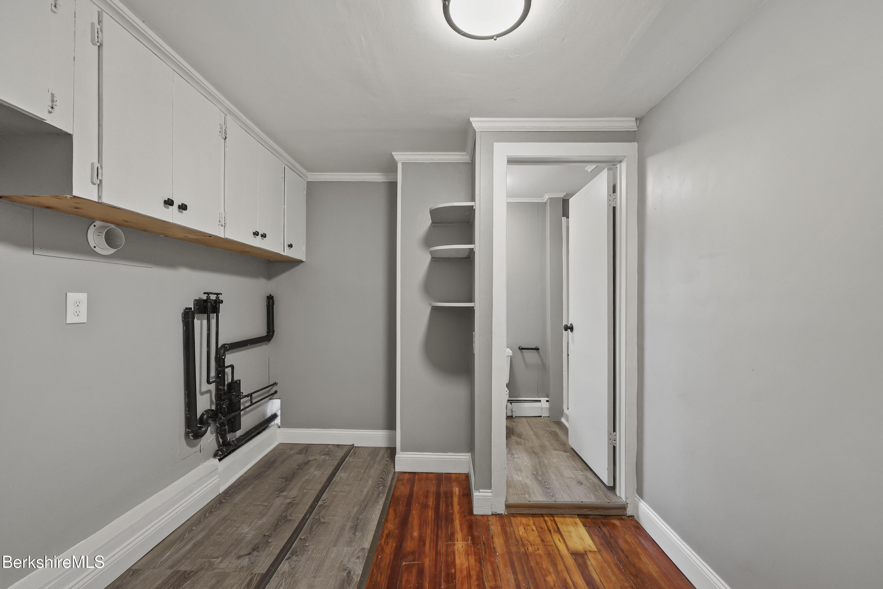 41-43 Reed Street Pittsfield, MA 01201 - Photo 46 of 56 a view of a hallway with wooden floor and staircase