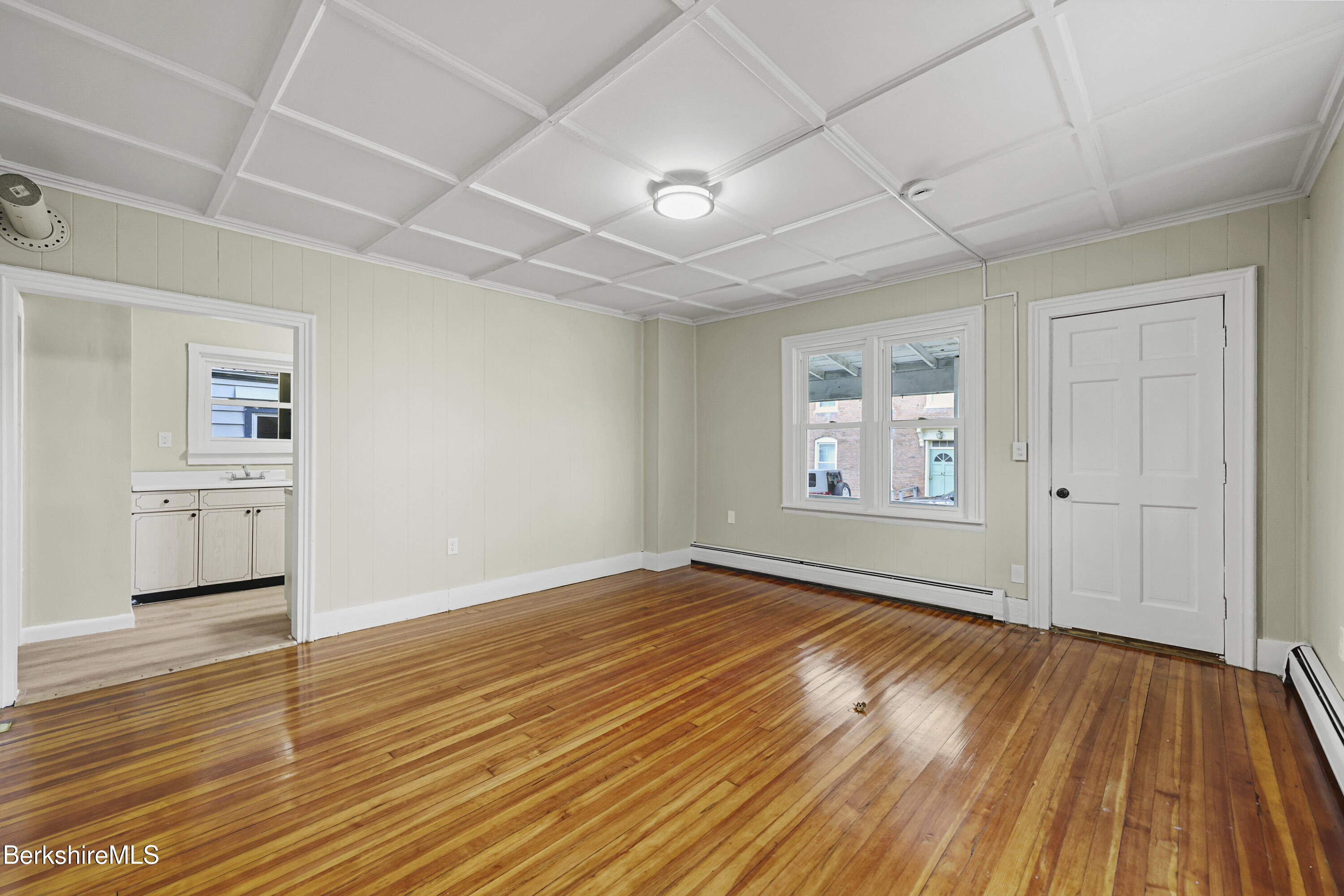 41-43 Reed Street Pittsfield, MA 01201 - Photo 6 of 56 an empty room with wooden floor cabinet and windows