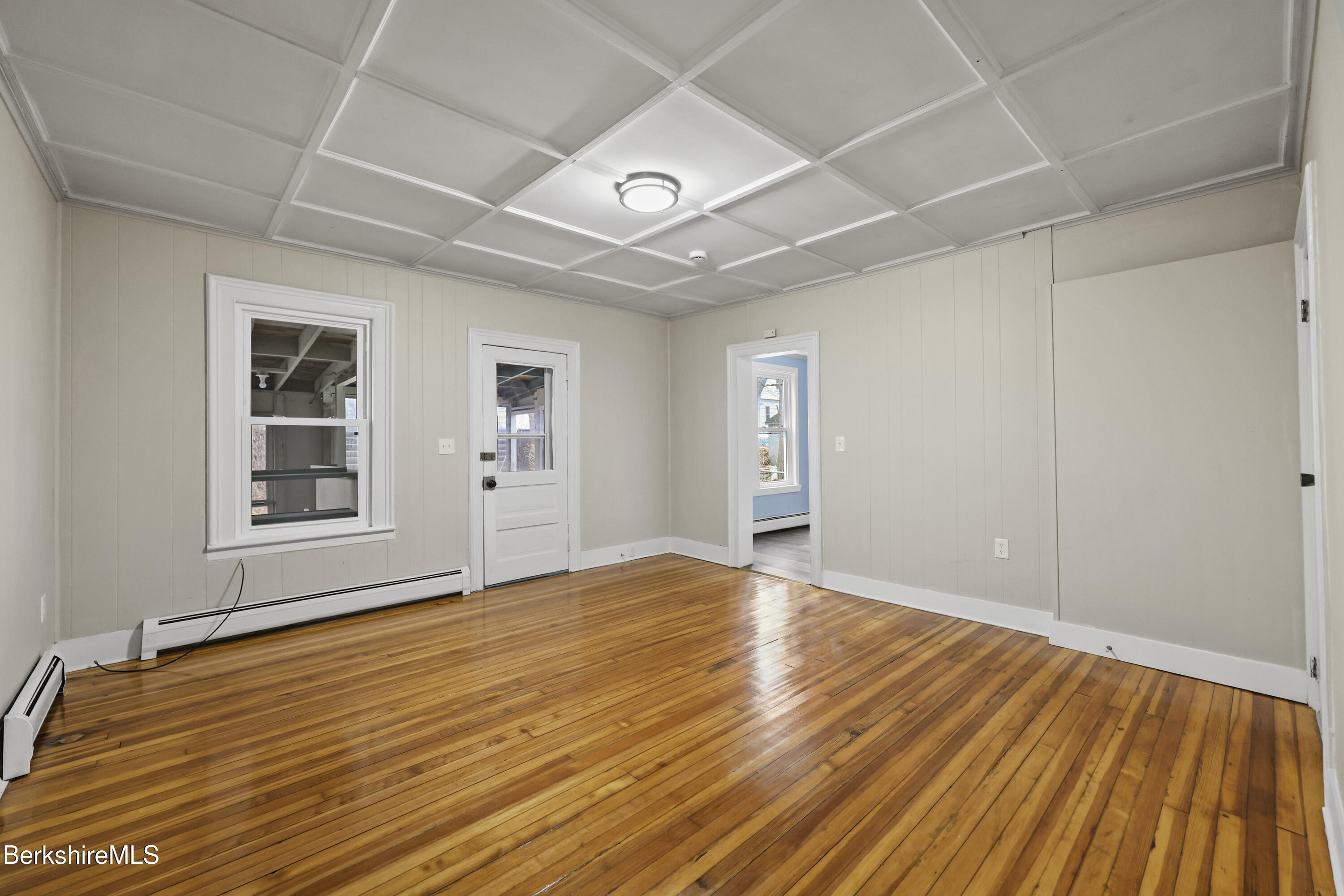 41-43 Reed Street Pittsfield, MA 01201 - Photo 8 of 56 a view of an empty room with window and wooden floor