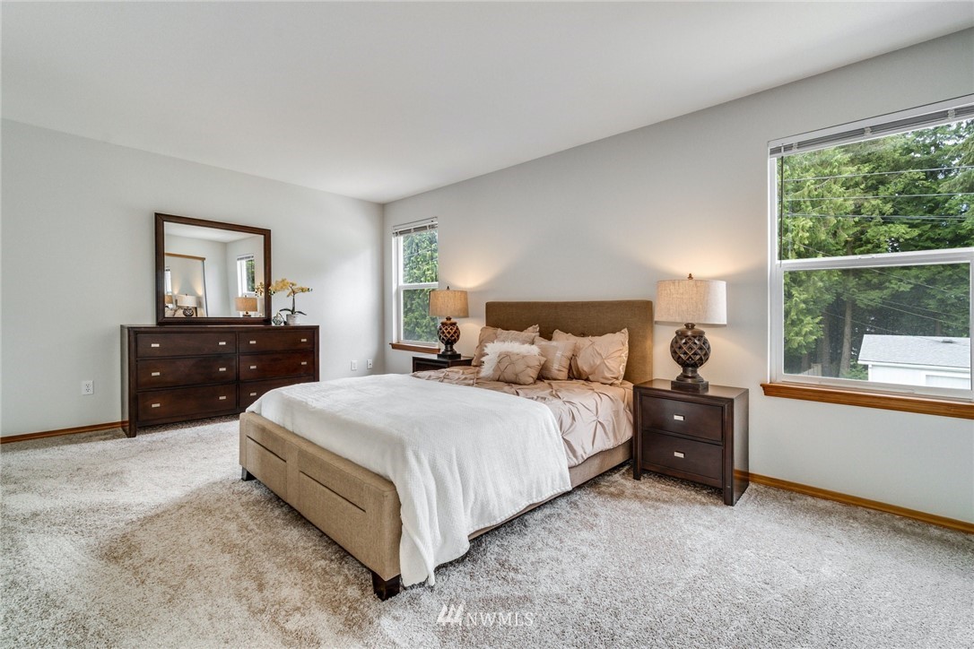 19212 1st Avenue West Bothell, WA 98012 - Photo 15 of 22 a bedroom with a bed and a large window