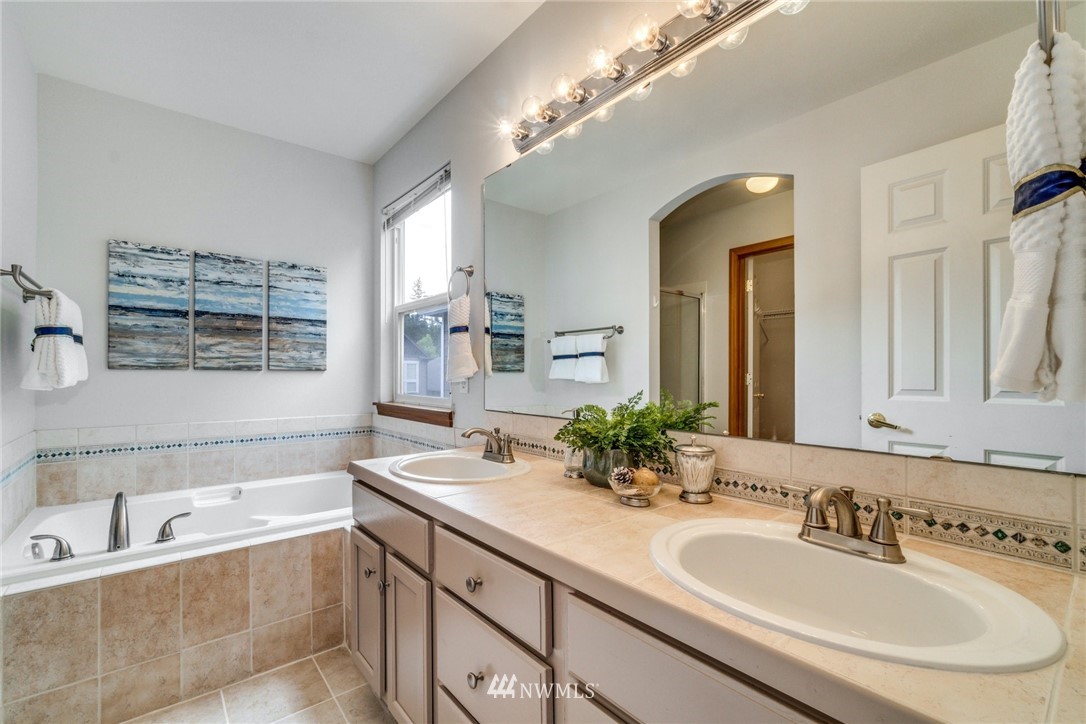 19212 1st Avenue West Bothell, WA 98012 - Photo 16 of 22 a bathroom with a bathtub a sink and mirror