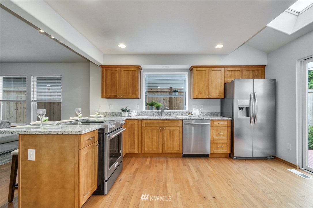 19212 1st Avenue West Bothell, WA 98012 - Photo 7 of 22 a kitchen with stainless steel appliances granite countertop a sink stove and refrigerator
