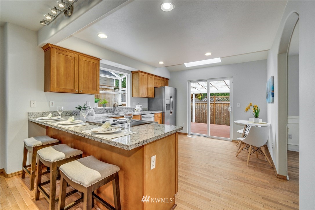 19212 1st Avenue West Bothell, WA 98012 - Photo 8 of 22 a view of kitchen island dining area wooden floor and a sink