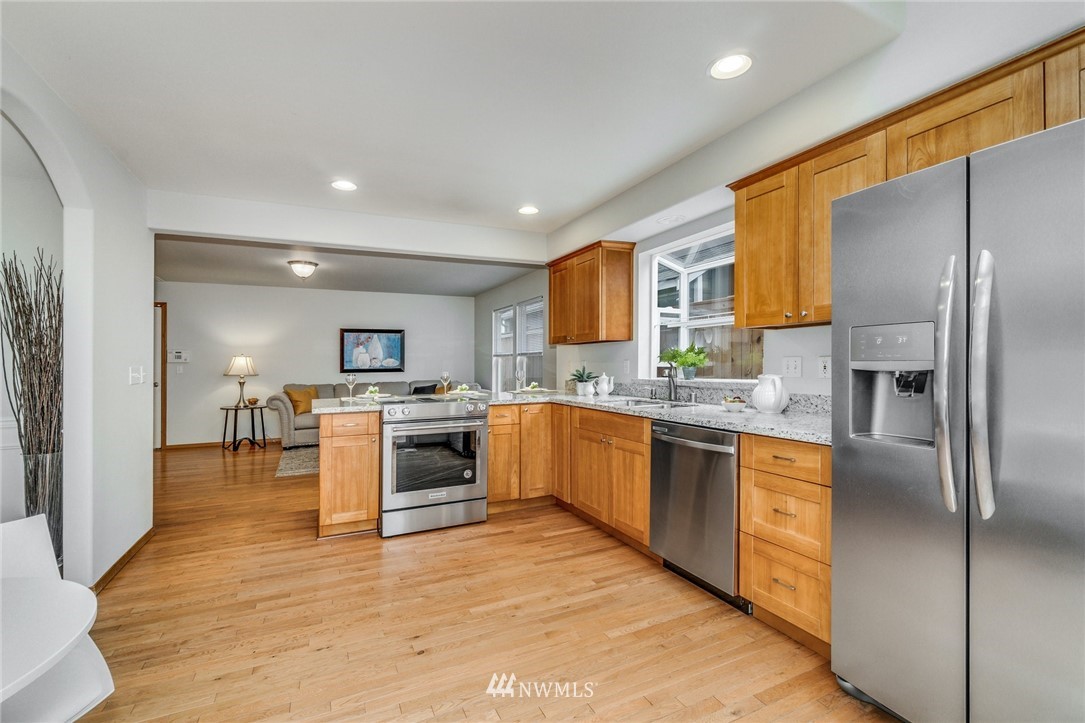 19212 1st Avenue West Bothell, WA 98012 - Photo 9 of 22 a large kitchen with cabinets wooden floor and stainless steel appliances
