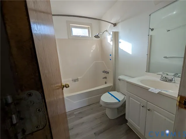 a bathroom with a double vanity sink toilet mirror and shower