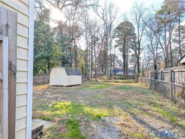 a view of a yard with a house and large trees