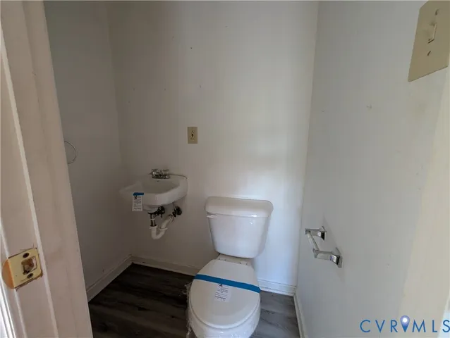 a white toilet sitting in a bathroom next to a sink