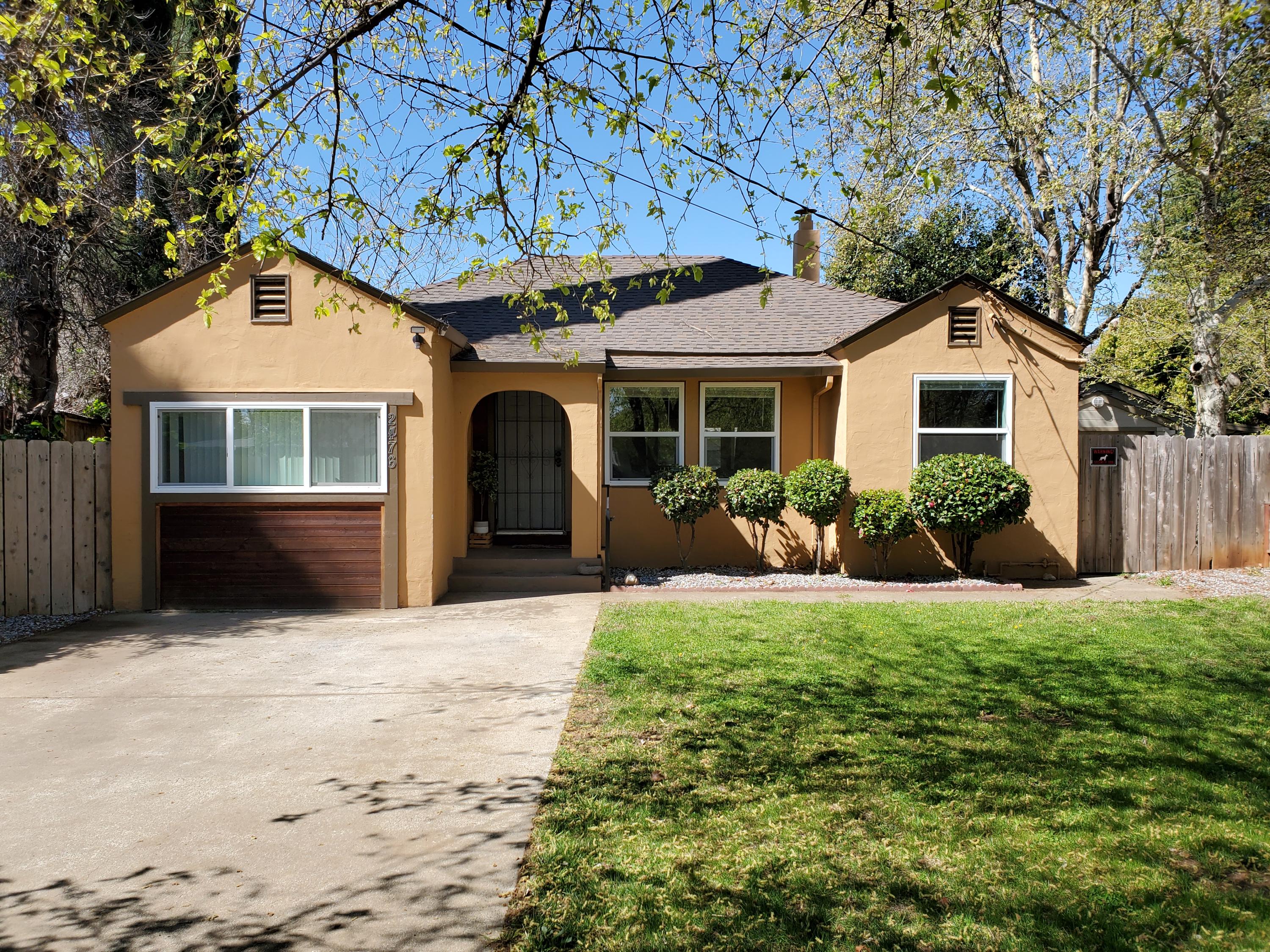 2476 California Street Redding, CA 96001 - Photo 2 of 32 a front view of a house with a yard and garage