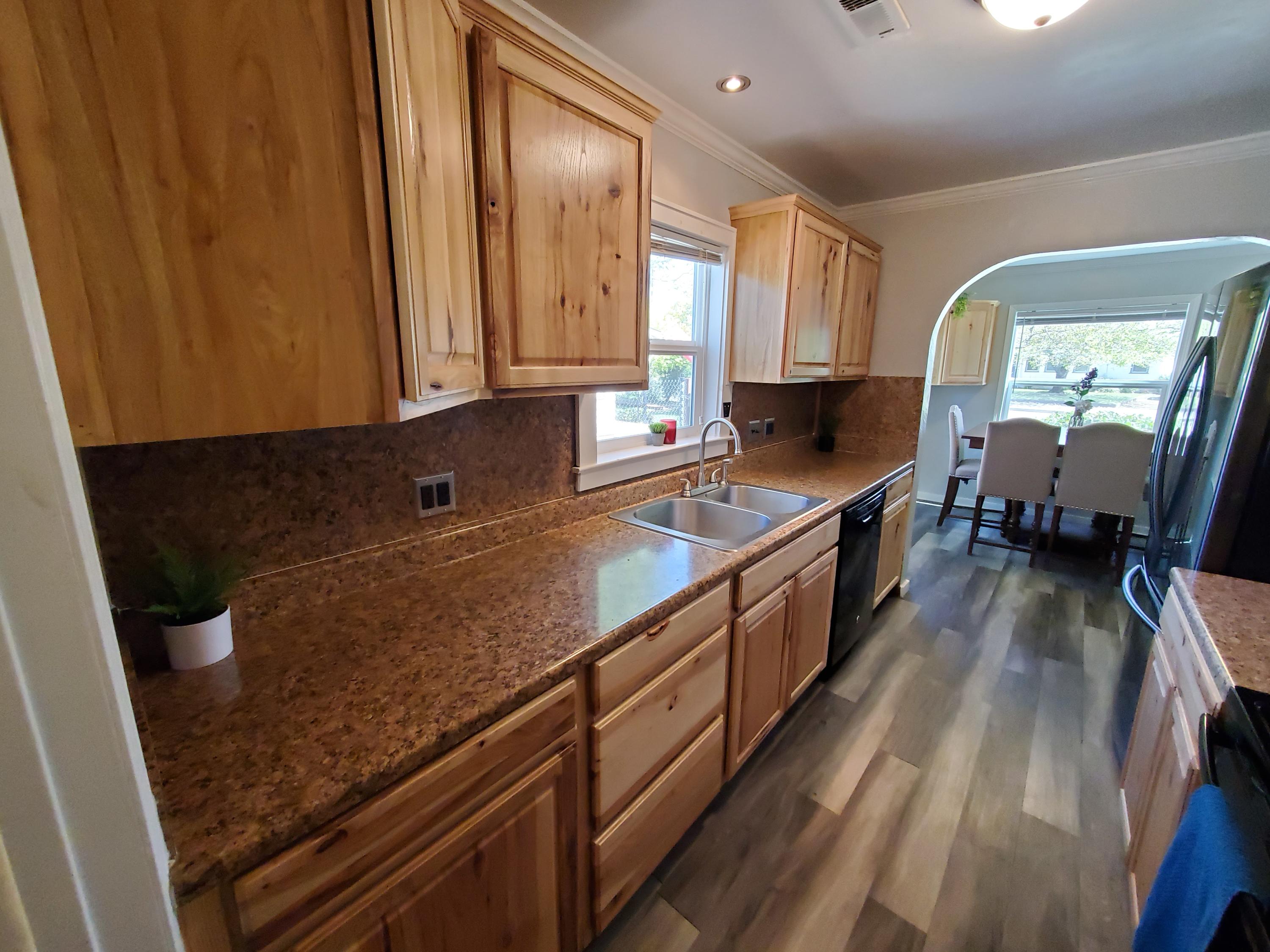 2476 California Street Redding, CA 96001 - Photo 24 of 32 a kitchen with stainless steel appliances granite countertop a stove a sink and a microwave