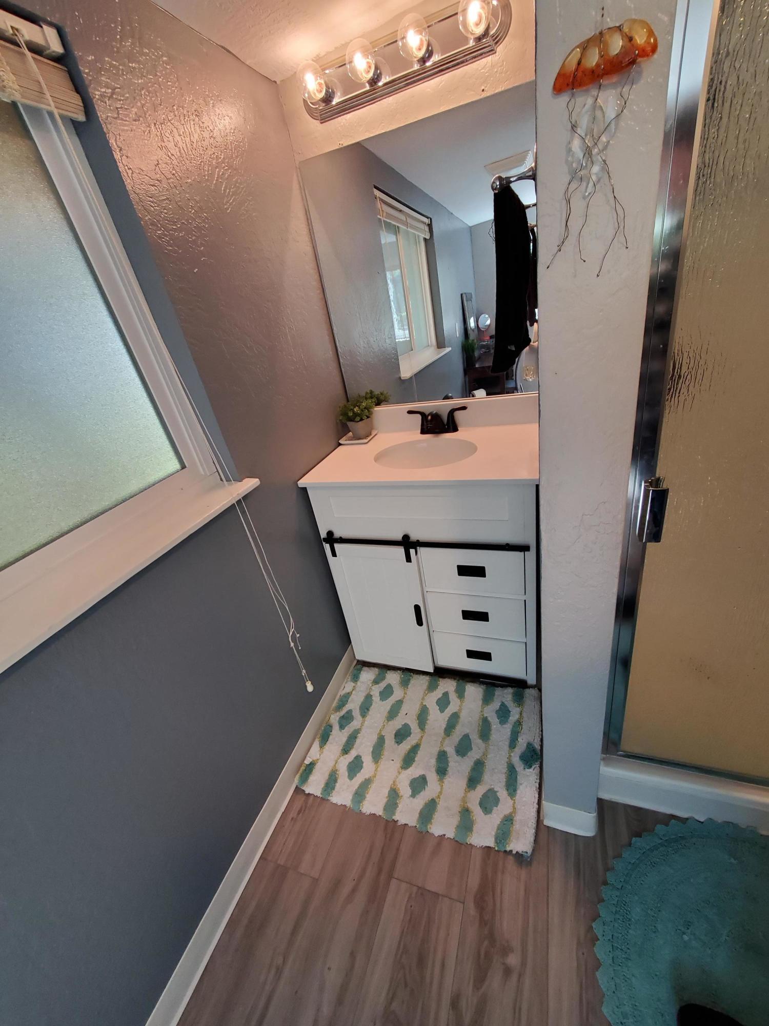 2476 California Street Redding, CA 96001 - Photo 29 of 32 a bathroom with a sink mirror and vanity