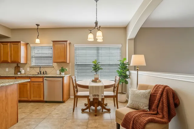 a kitchen with stainless steel appliances granite countertop a sink and a stove