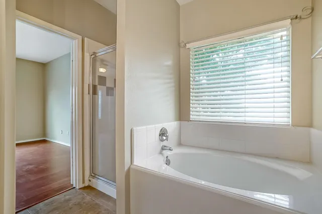 a bathroom with a bathtub and a shower