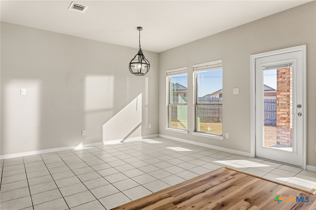 7617 Lee Hall Loop Temple, TX 76502 - Photo 11 of 26 a view of an empty room with window and chandelier