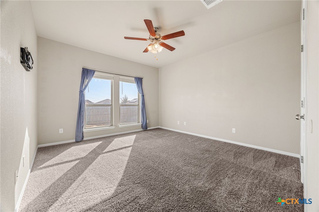 7617 Lee Hall Loop Temple, TX 76502 - Photo 12 of 26 an empty room with windows and fan