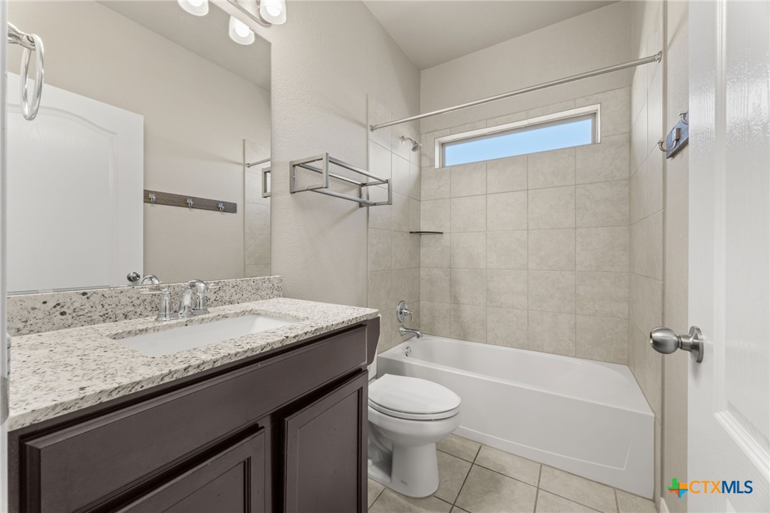 7617 Lee Hall Loop Temple, TX 76502 - Photo 16 of 26 a bathroom with a granite countertop sink toilet and shower