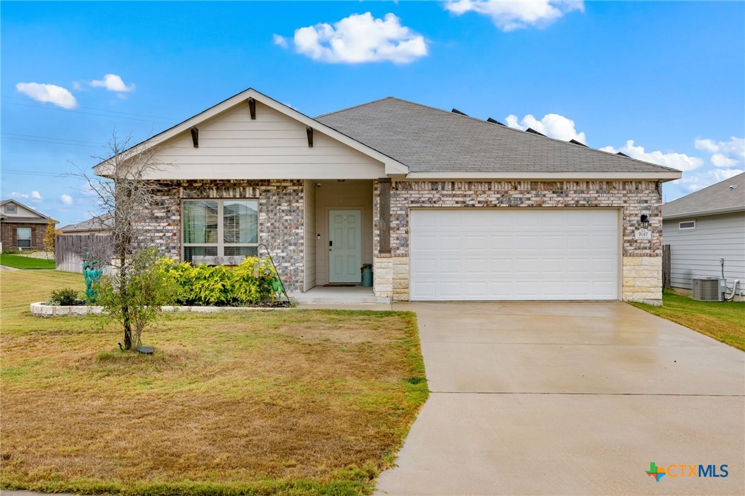 7617 Lee Hall Loop Temple, TX 76502 - Photo 2 of 26 a front view of a house with a yard and garage
