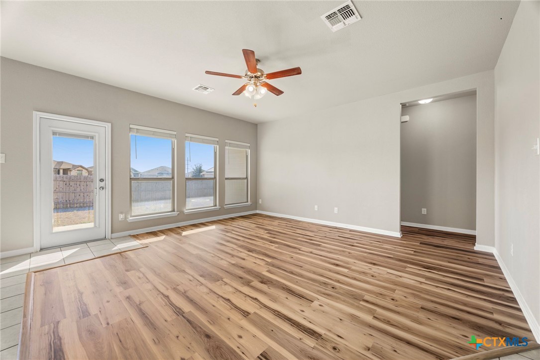7617 Lee Hall Loop Temple, TX 76502 - Photo 5 of 26 a view of an empty room with a window and wooden floor