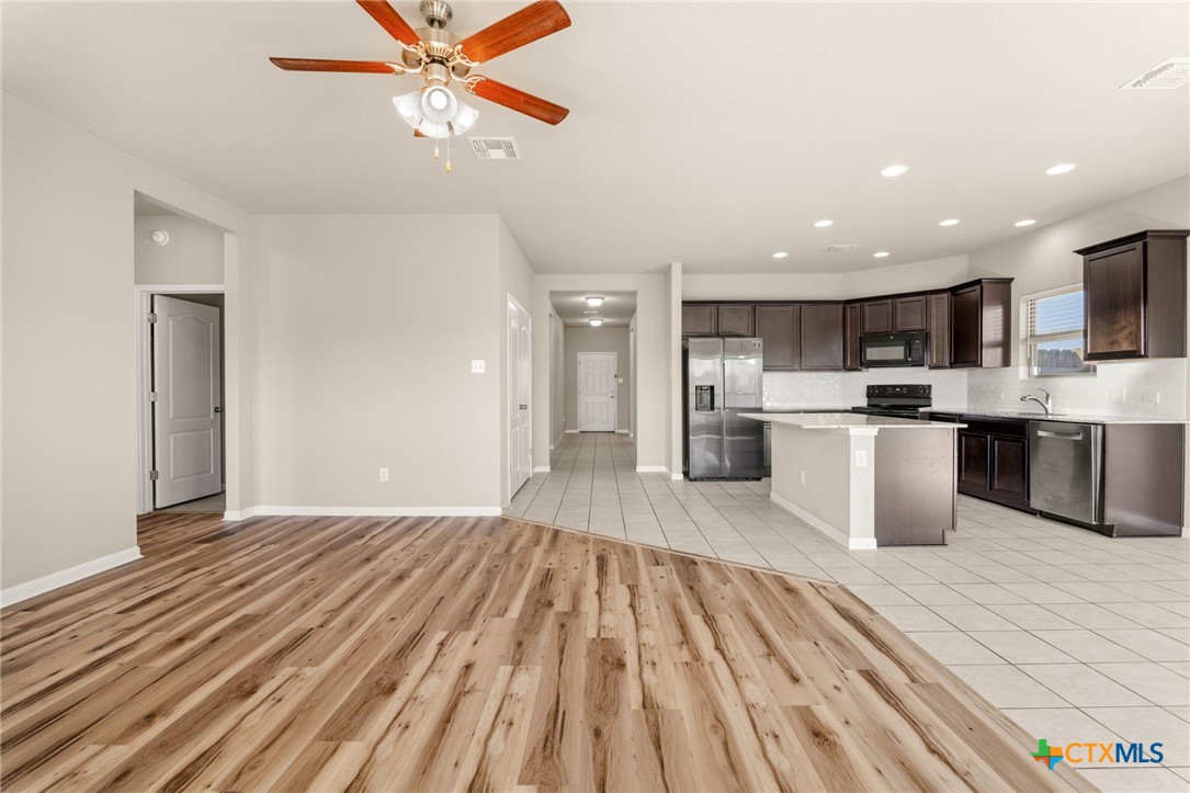 7617 Lee Hall Loop Temple, TX 76502 - Photo 6 of 26 a open kitchen with kitchen island a island a stove a sink and a refrigerator