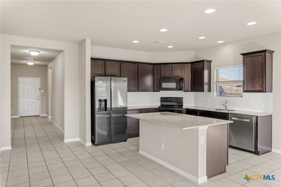 7617 Lee Hall Loop Temple, TX 76502 - Photo 8 of 26 a kitchen with stainless steel appliances granite countertop a refrigerator and a stove top oven