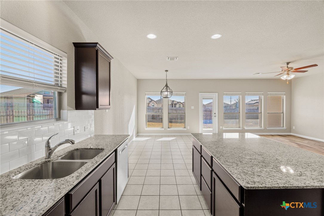 7617 Lee Hall Loop Temple, TX 76502 - Photo 10 of 26 a kitchen with granite countertop a sink and a stove