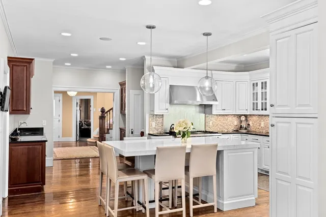 a kitchen with stainless steel appliances kitchen island granite countertop a sink and cabinets
