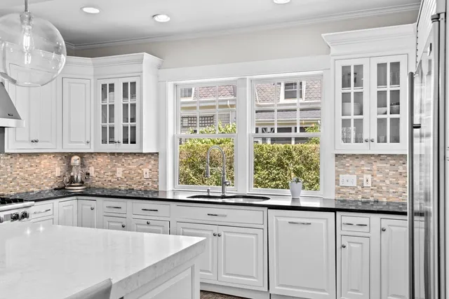a kitchen with granite countertop a sink and a window
