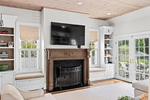 a living room with furniture a flat screen tv and a fireplace