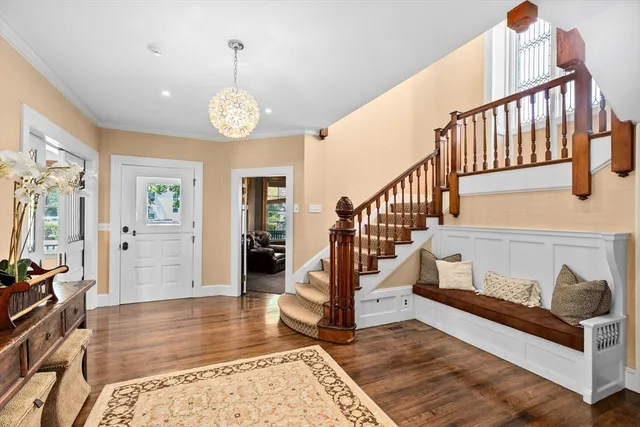 a view of entryway and hall with wooden floor