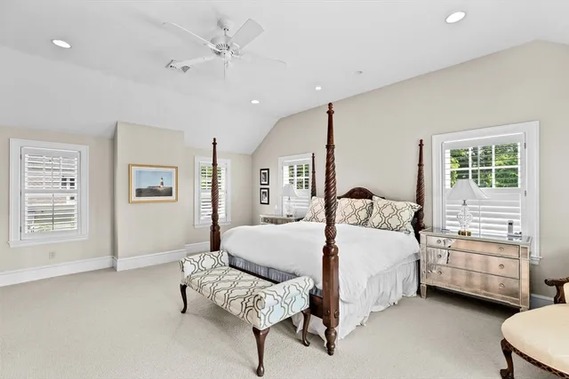 a bedroom with a bed a couch and dresser