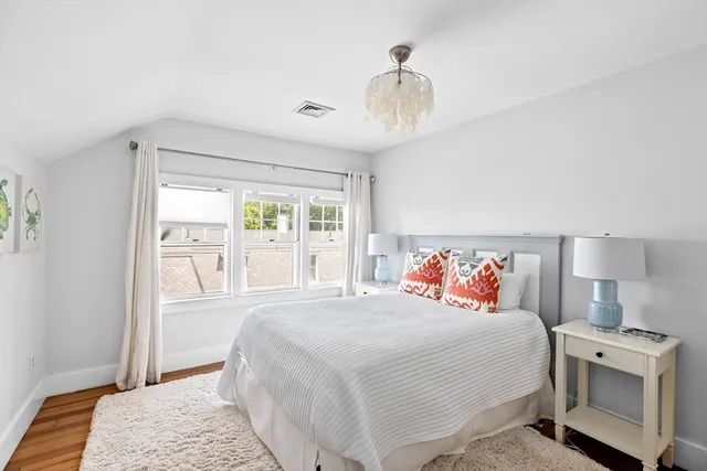 a bedroom with a large bed and a window