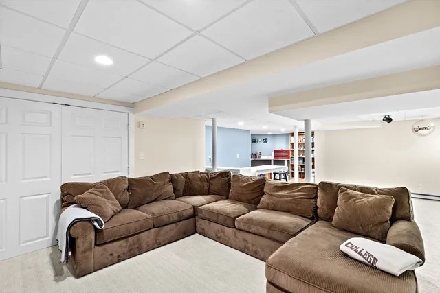 a living room with furniture a couch and a ceiling fan