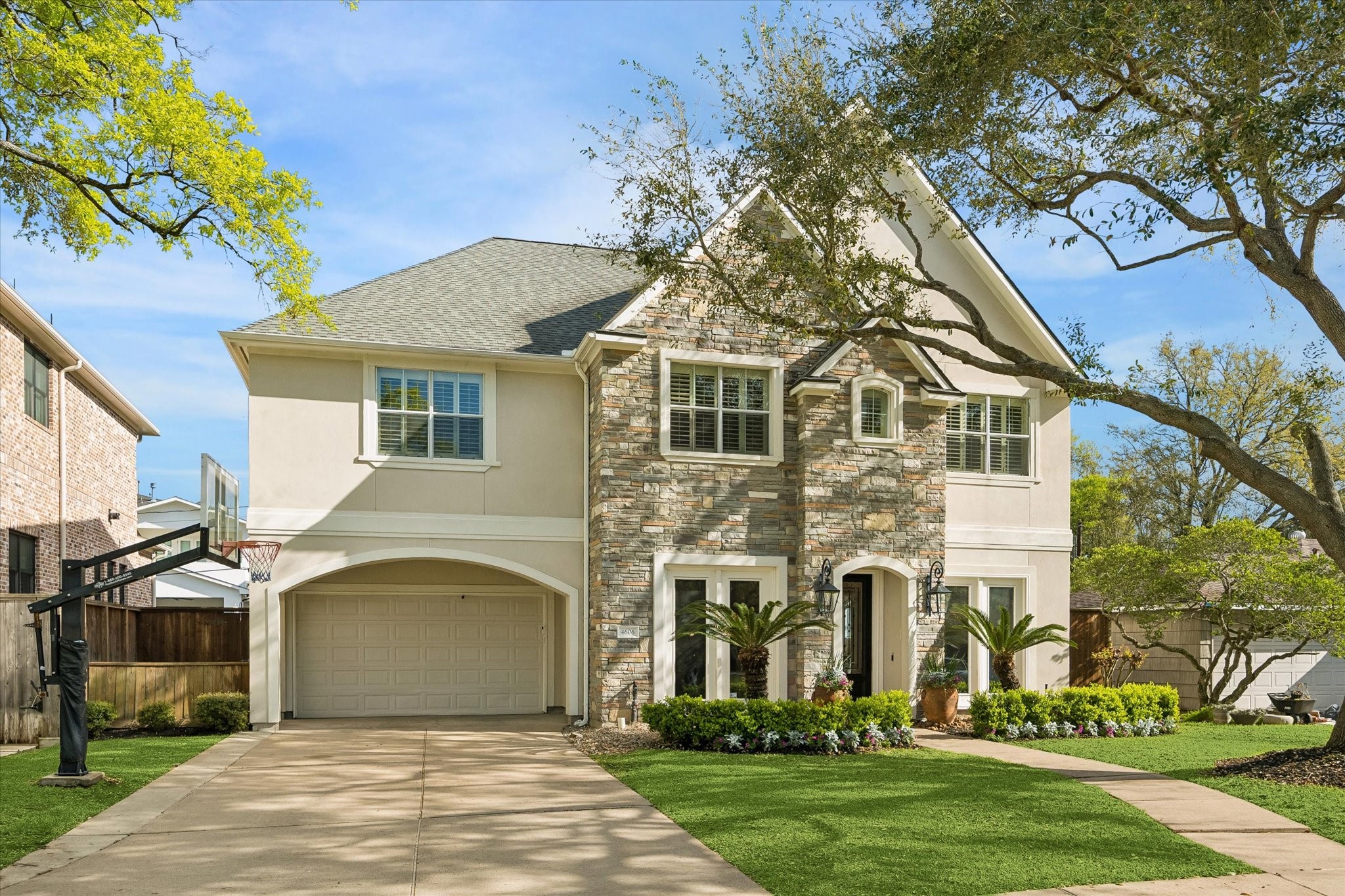 a front view of a house with a garden