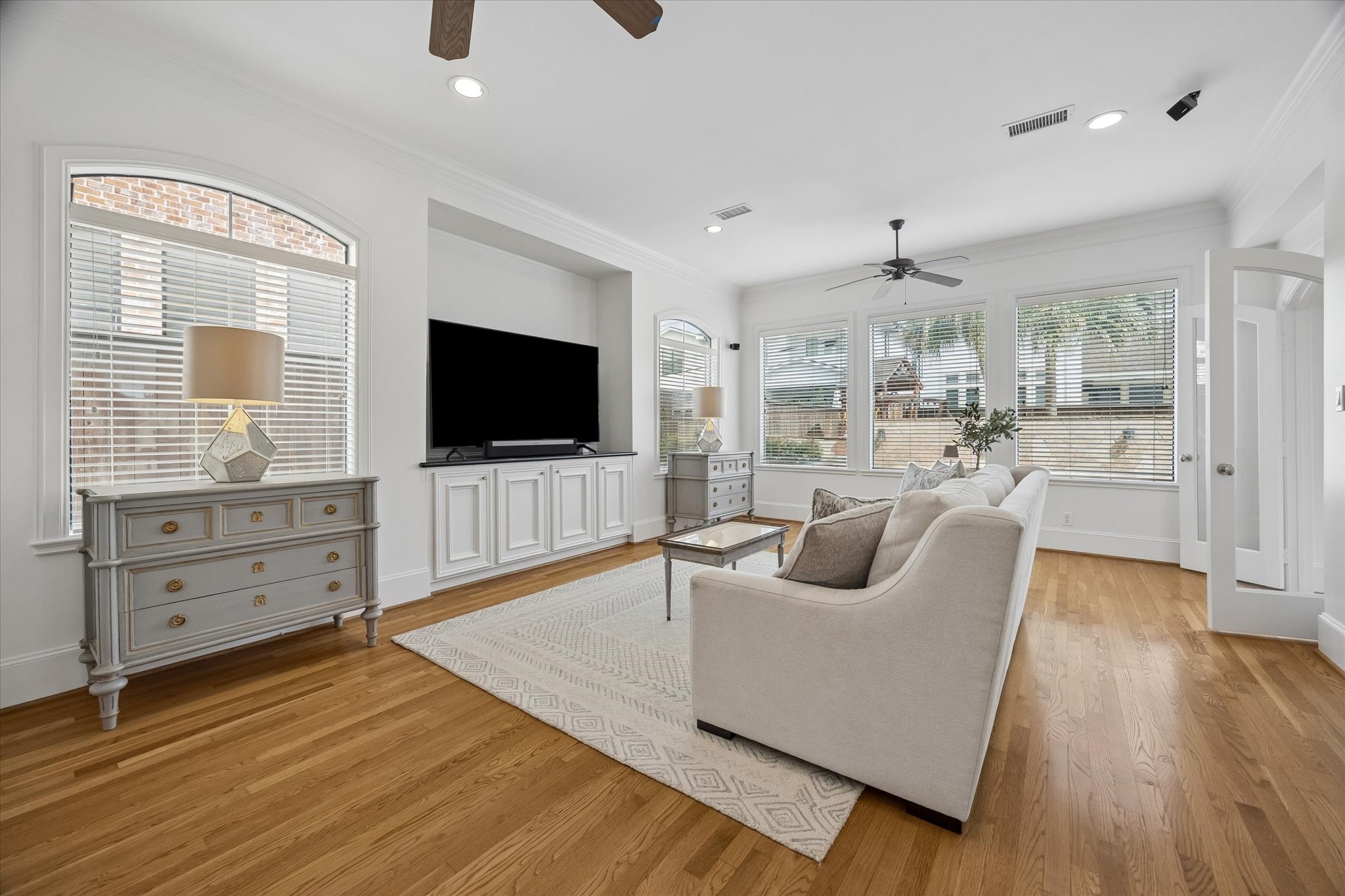 4606 Birch Street Bellaire, TX 77401 - Photo 18 of 45 a living room with furniture and a flat screen tv