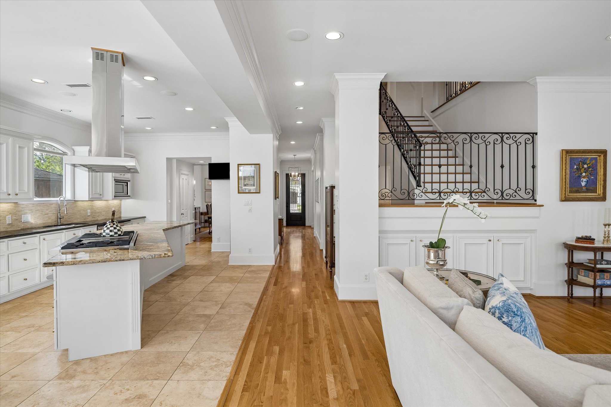 4606 Birch Street Bellaire, TX 77401 - Photo 19 of 45 a living room with stainless steel appliances furniture a rug kitchen view and a chandelier