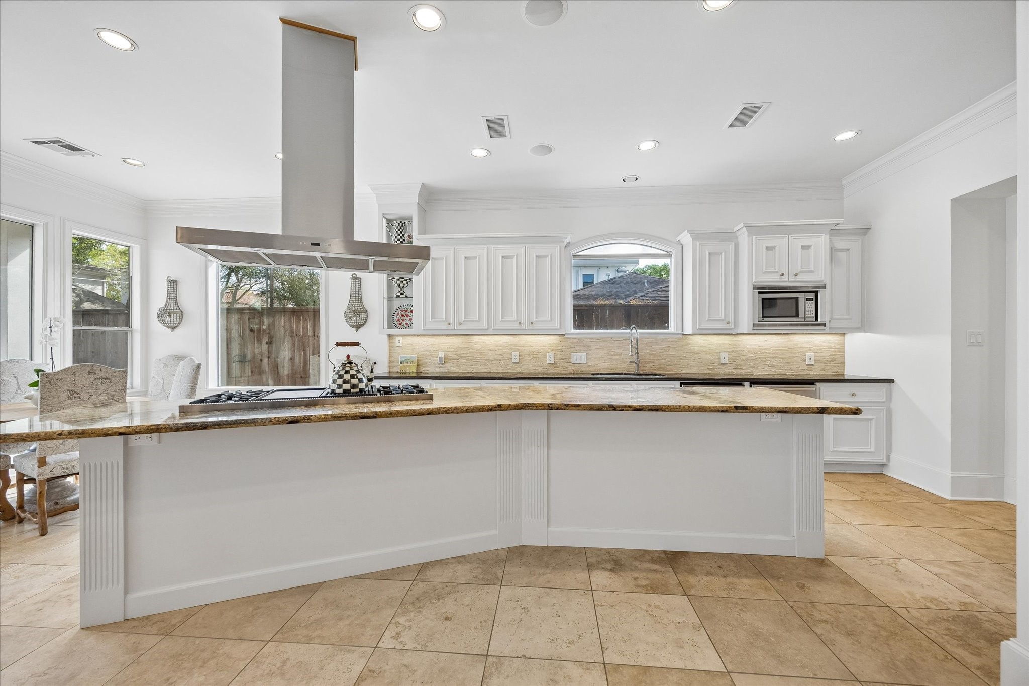 4606 Birch Street Bellaire, TX 77401 - Photo 20 of 45 a large kitchen with granite countertop a sink and cabinets