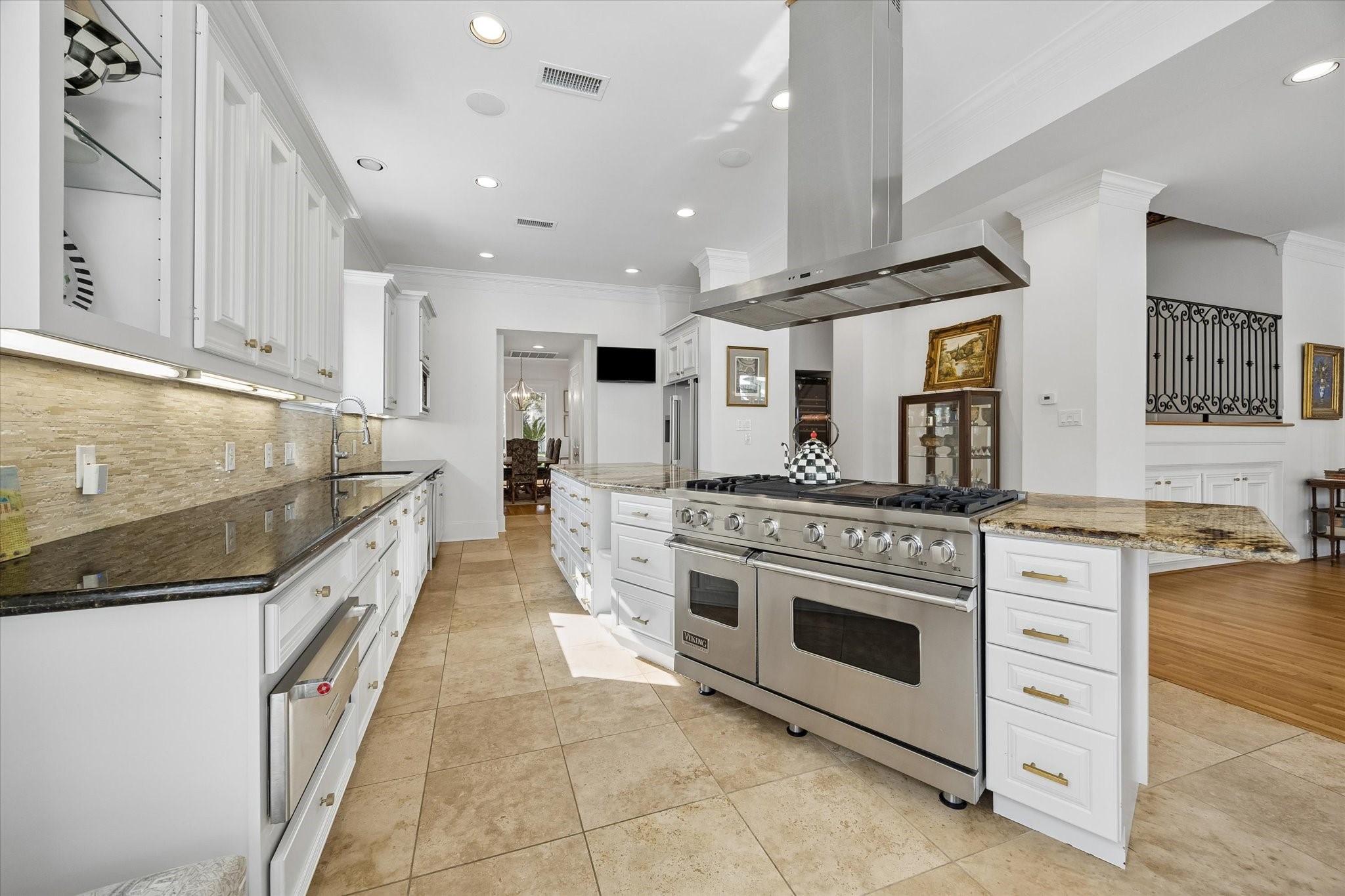4606 Birch Street Bellaire, TX 77401 - Photo 22 of 45 a large kitchen with stainless steel appliances granite countertop a stove and a sink