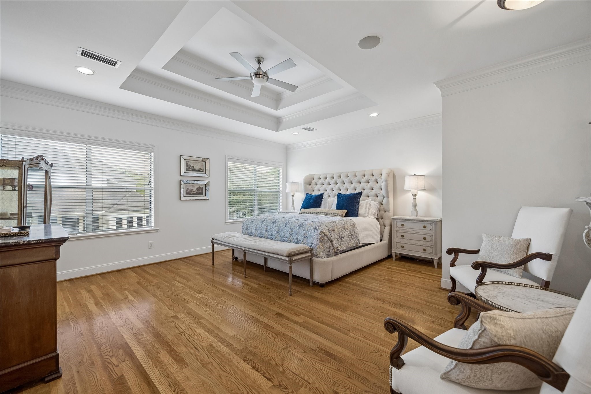 4606 Birch Street Bellaire, TX 77401 - Photo 25 of 45 a bedroom with a bed wooden floor and windows