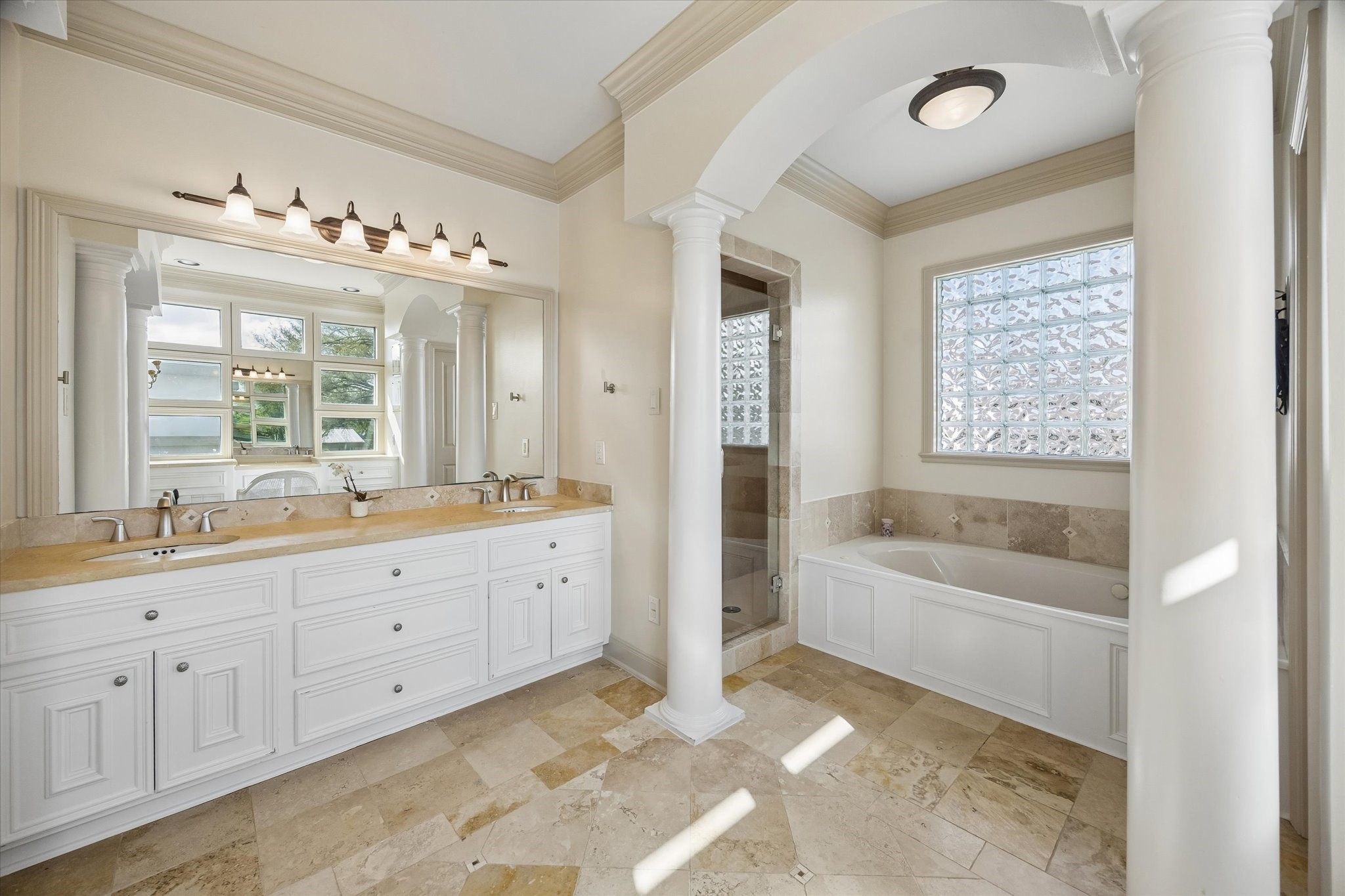 4606 Birch Street Bellaire, TX 77401 - Photo 28 of 45 a bathroom with a tub sink double vanity granite and tub