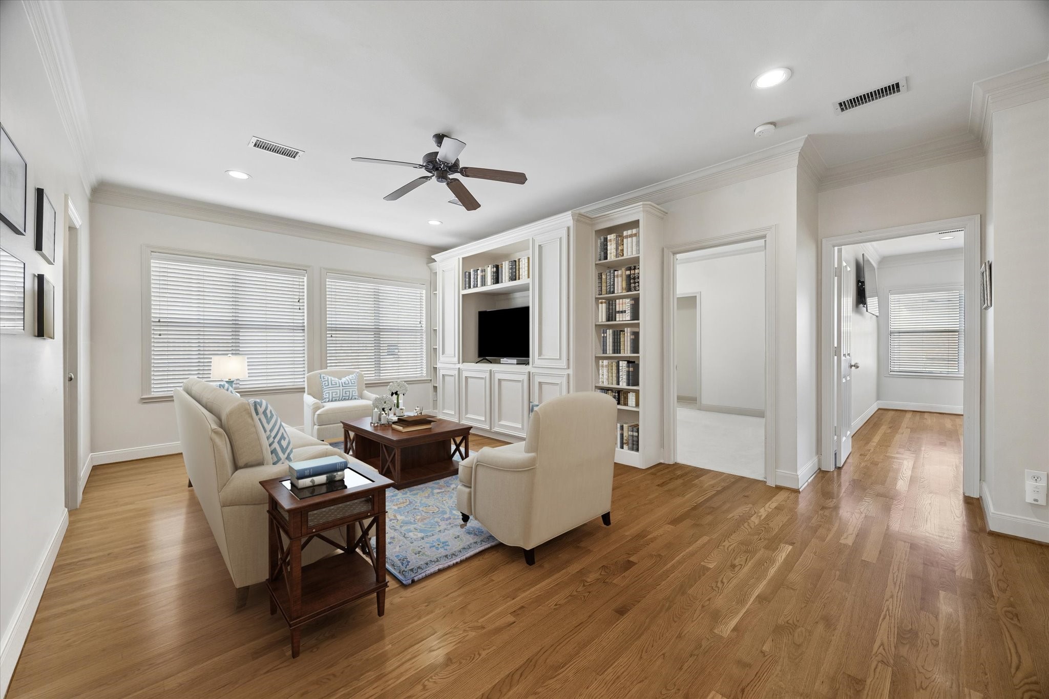 4606 Birch Street Bellaire, TX 77401 - Photo 31 of 45 a living room with furniture and a flat screen tv