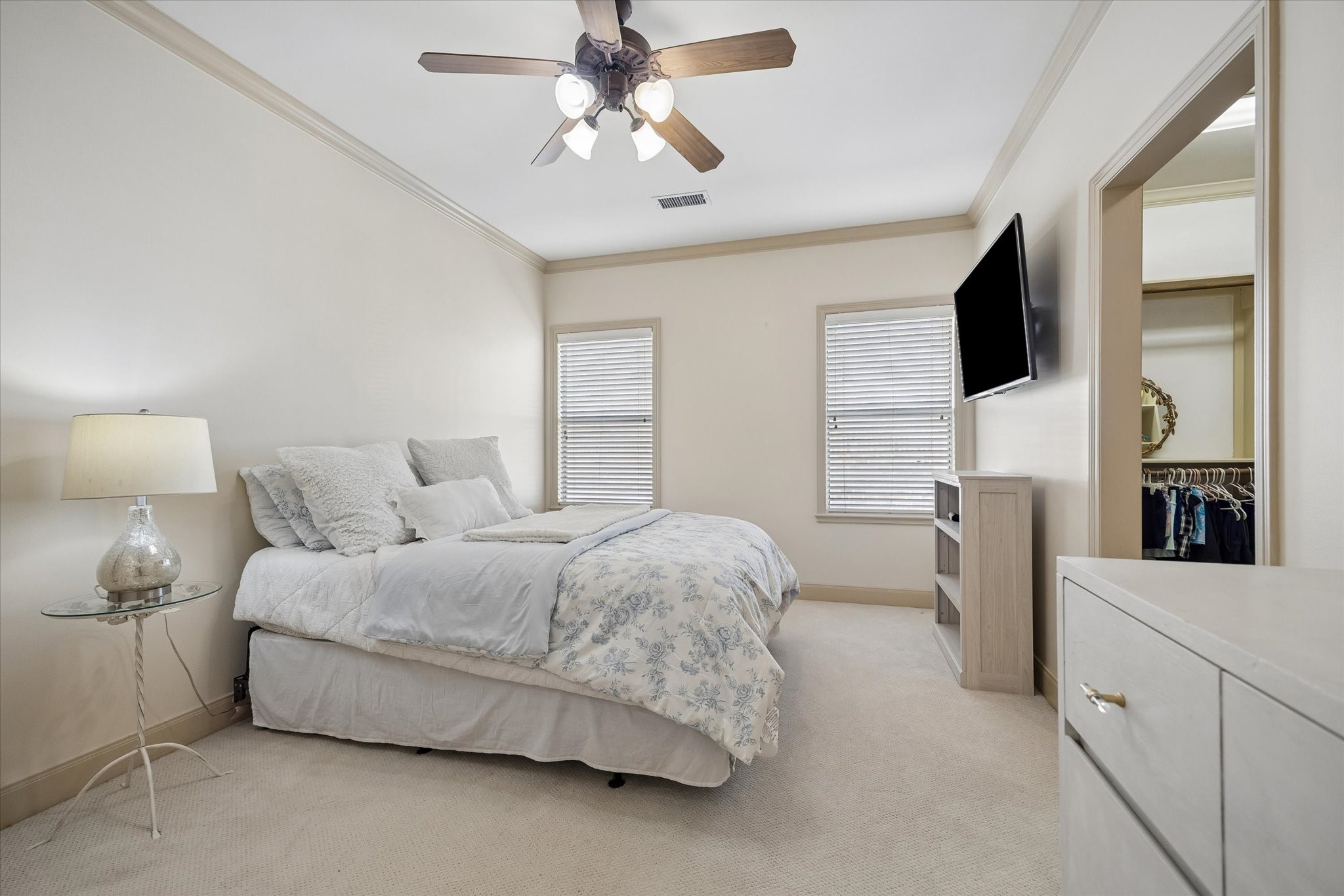 4606 Birch Street Bellaire, TX 77401 - Photo 32 of 45 a spacious bedroom with a bed and a flat screen tv
