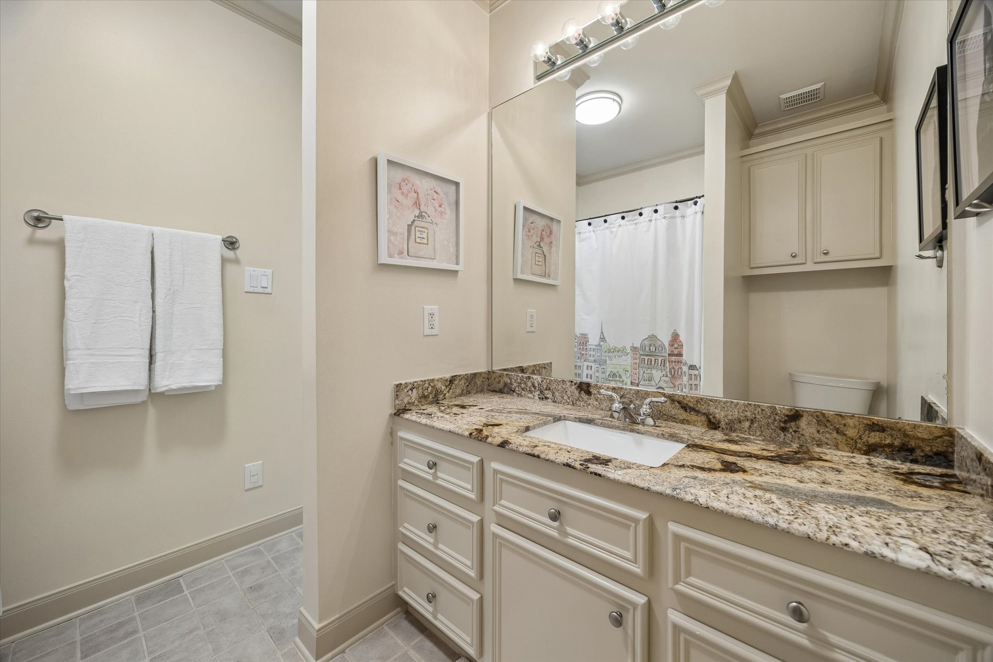4606 Birch Street Bellaire, TX 77401 - Photo 33 of 45 a bathroom with a granite countertop sink and a mirror
