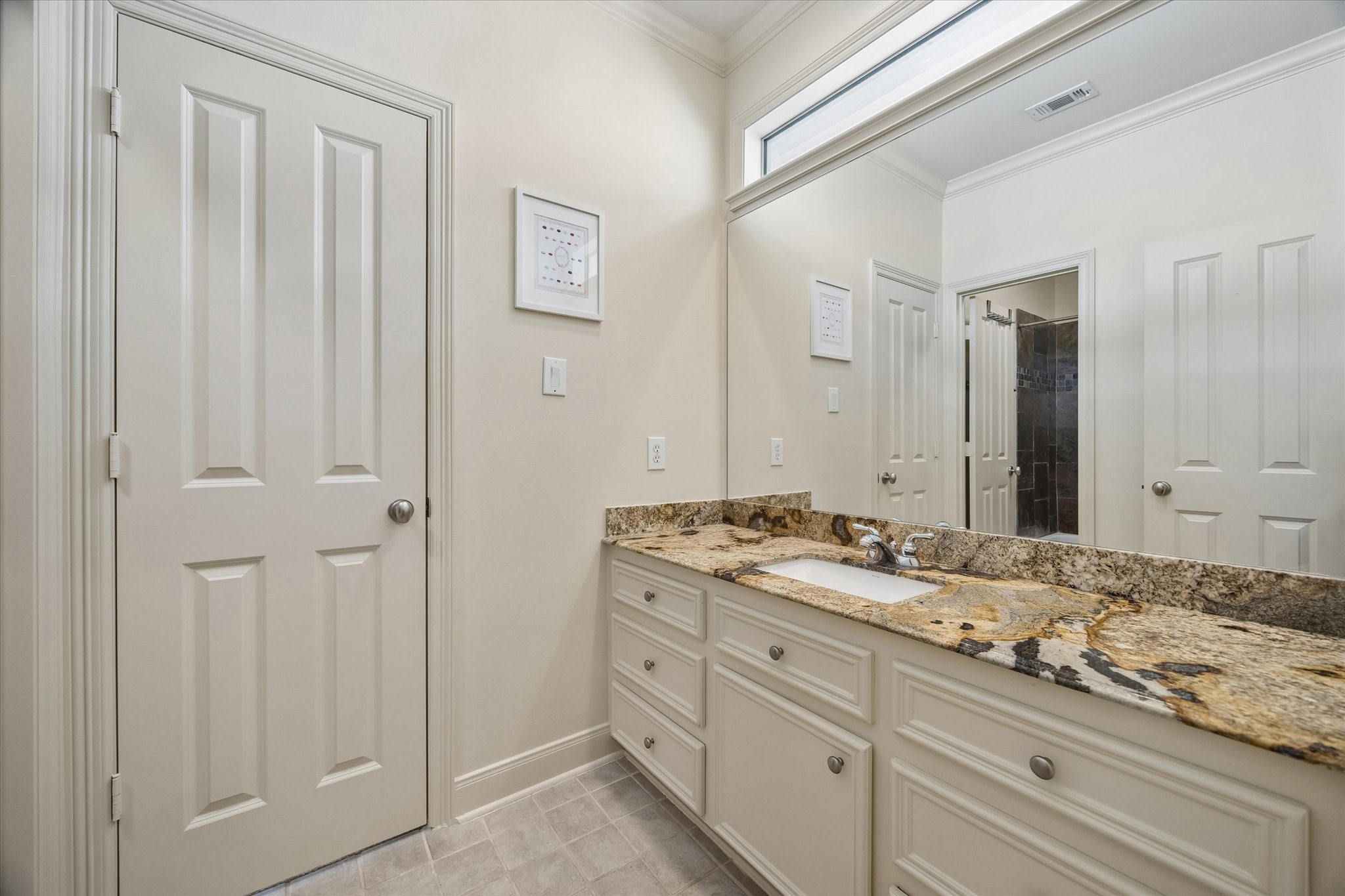 4606 Birch Street Bellaire, TX 77401 - Photo 35 of 45 a bathroom with a granite countertop sink and a mirror