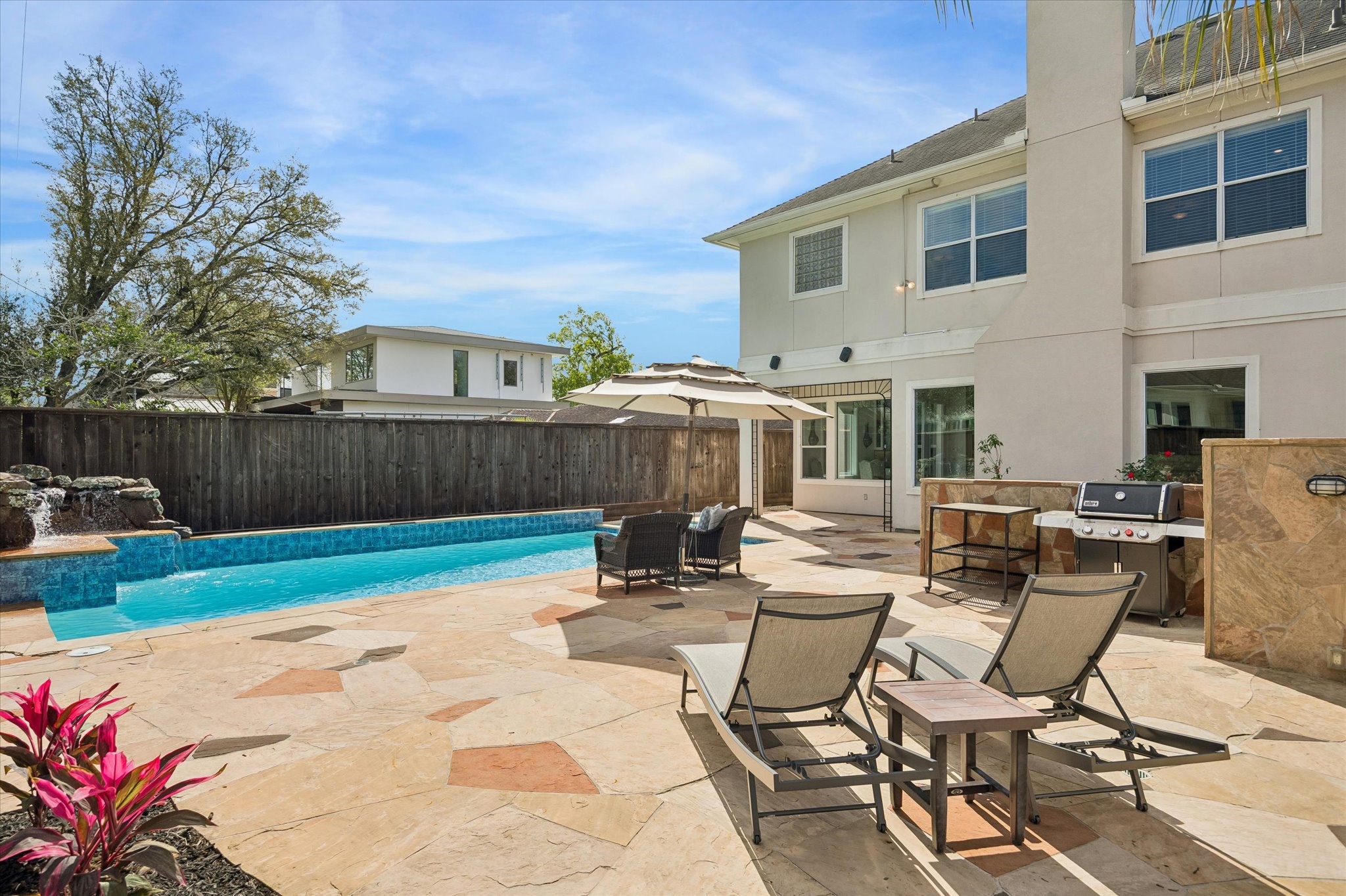 4606 Birch Street Bellaire, TX 77401 - Photo 42 of 45 a view of a patio with table and chairs with wooden fence and plants