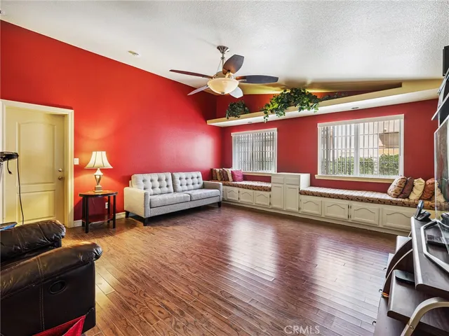 a bedroom with furniture and a large window